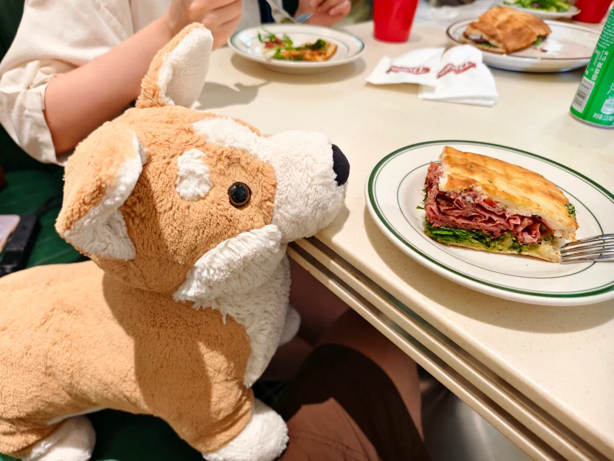 A plush dog joining lunch at the table